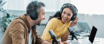 A man and woman talking into microphones